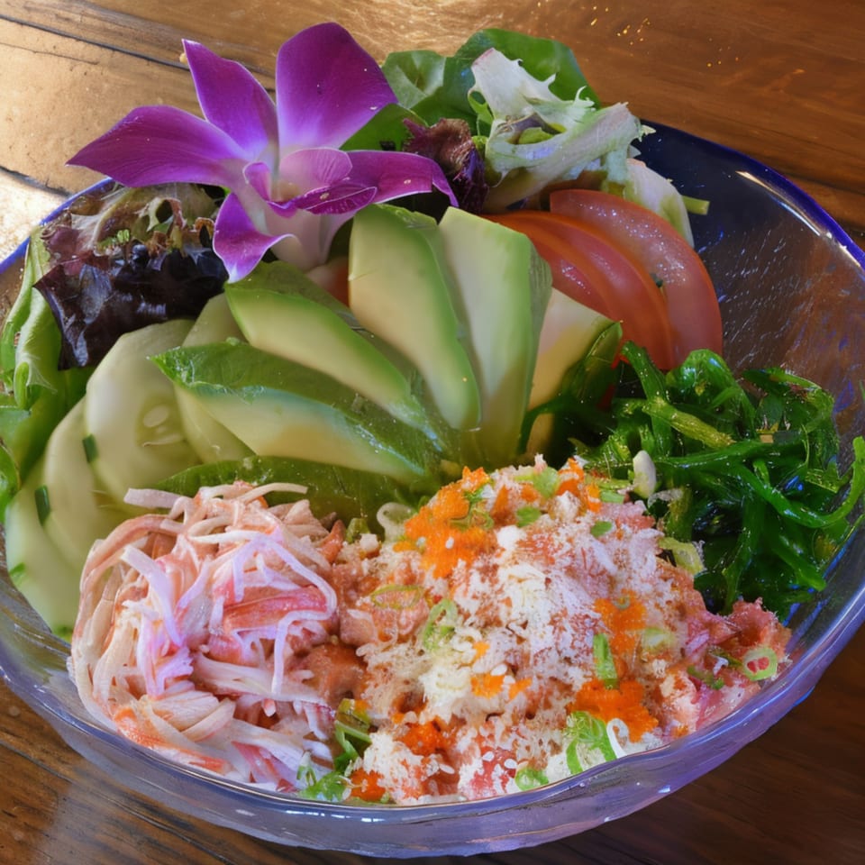 A colorful Japanese salad with crab, avocado, cucumber, seaweed, and a purple orchid garnish.